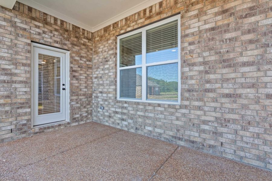 Covered patio area featuring a textured concrete surface
