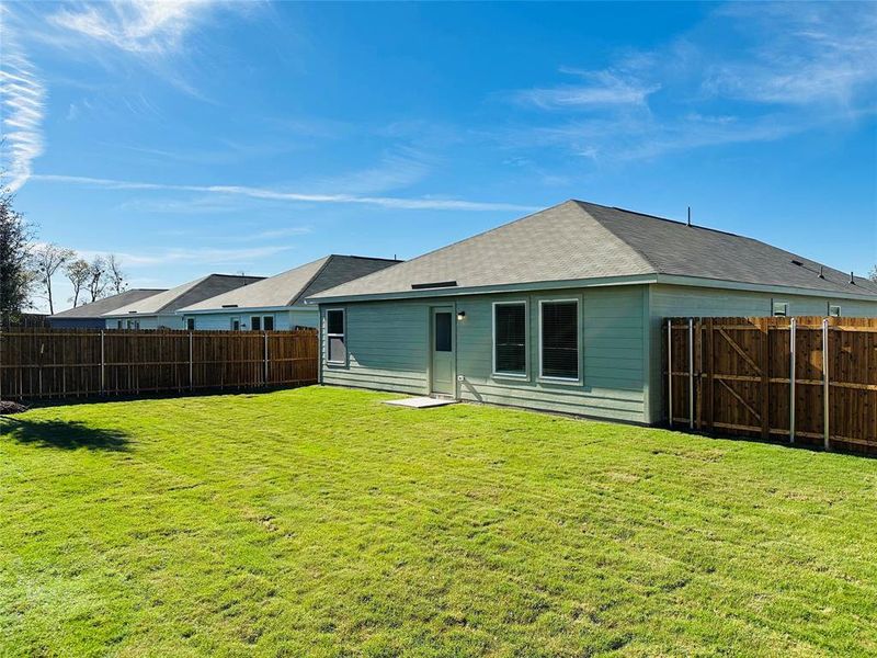 Rear view of property featuring a yard