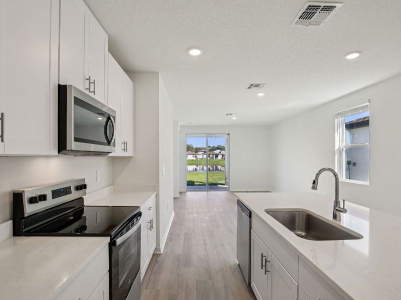 Furnished interior view inside a new home in The Grove at Stuart Crossing - Premier Series, Bartow (Image 5).