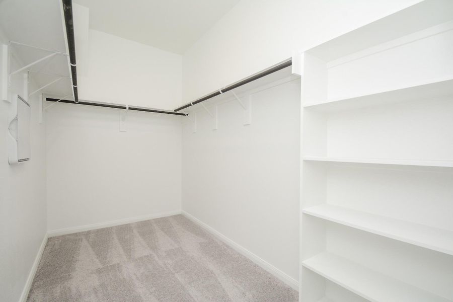 Step into this expansive closet that has built-in storage.