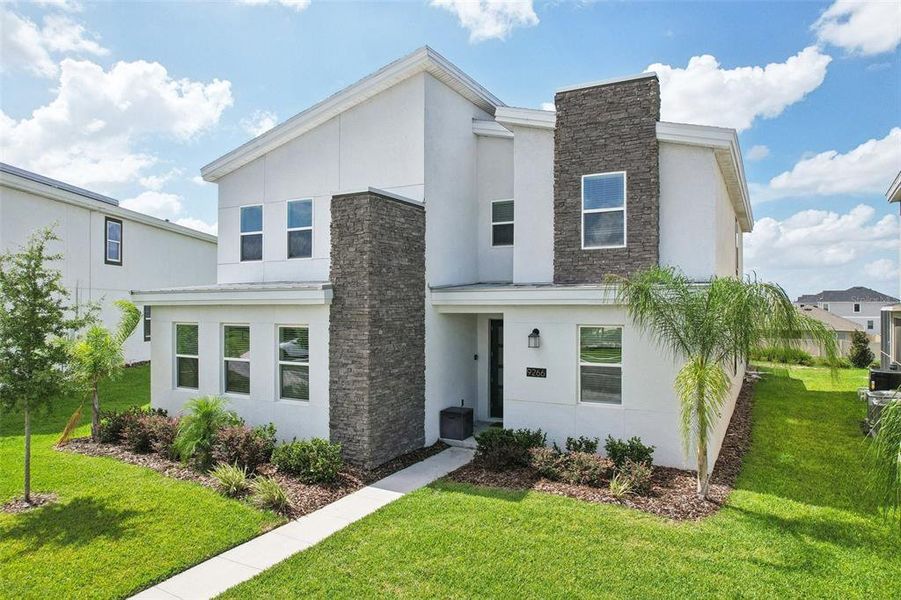 Front exterior of a new home in , Davenport, FL, highlighting curb appeal (Image 26).