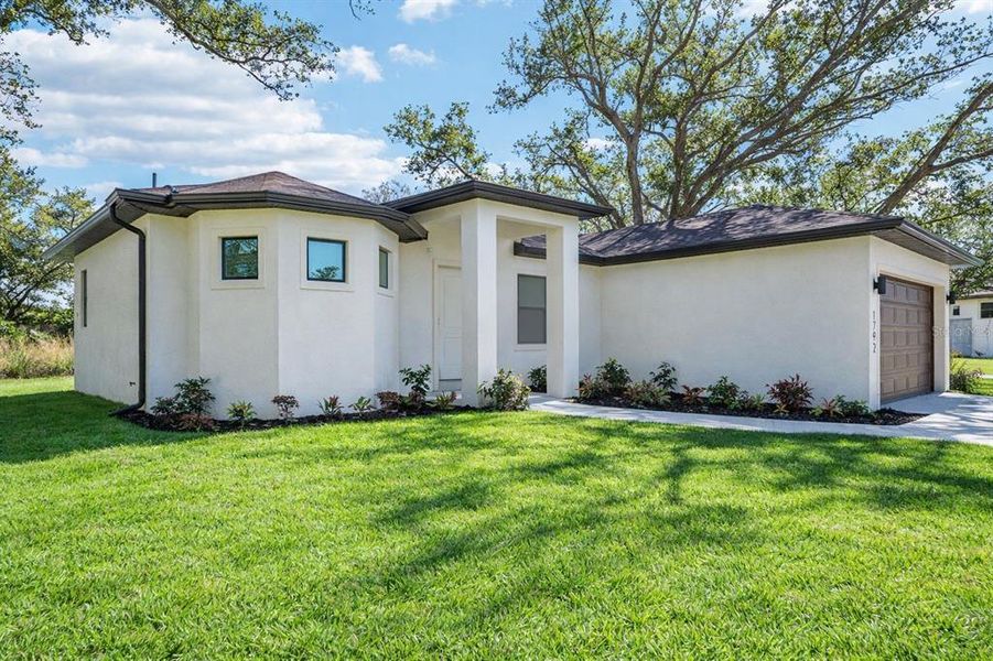 Front exterior of a new home in , North Port, FL, highlighting curb appeal (Image 28). Front exterior of a new home in , North Port, FL, highlighting curb appeal (Image 28).