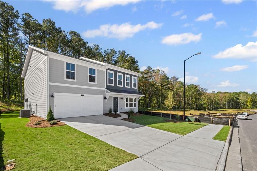 Front exterior of a new home in Sage Woods, Dallas, GA, highlighting curb appeal (Image 1).