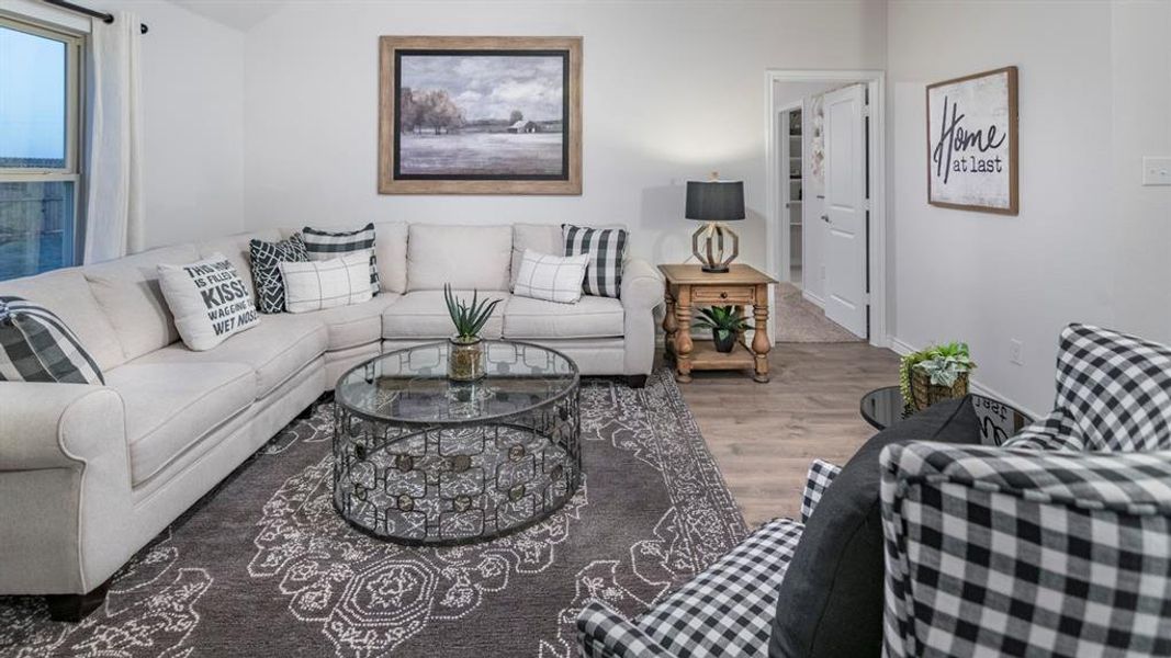 Living area featuring wood finished floors and baseboards Living area featuring wood finished floors and baseboards