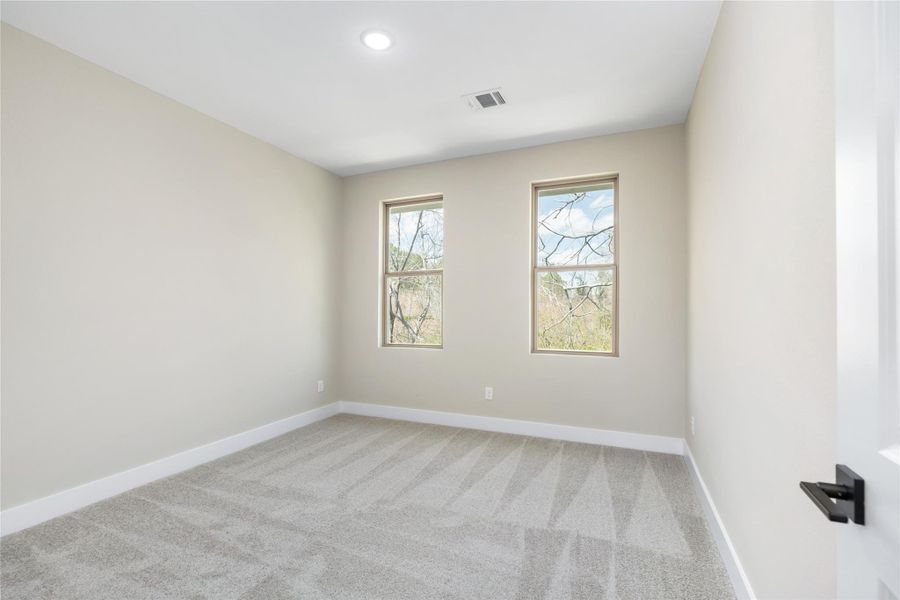 This bright secondary bedrooms offer versatile space. Two large windows flood the room with natural light. Whether used as a cozy retreat for family, a welcoming space for visitors, or a productive home office, this room offers endless possibilities to suit your needs.