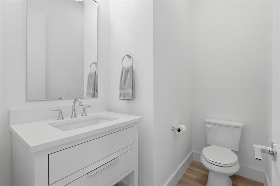Modern vanity with an integrated rectangular sink, chrome widespread faucet, and a large wall mirror