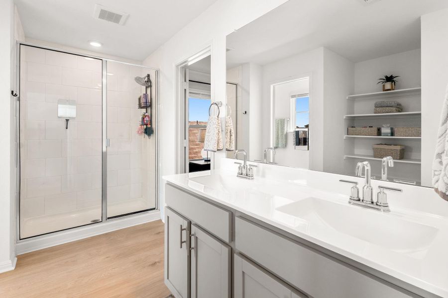 Primary bathroom featuring a spacious shower and dual vanity. Primary bathroom featuring a spacious shower and dual vanity.