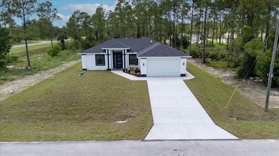Front exterior of a new home in , Lehigh Acres, FL, highlighting curb appeal (Image 30).
