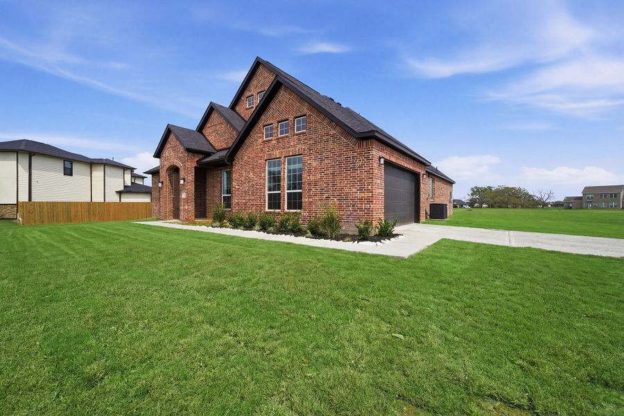 Front exterior of a new home in Suncreek Estates, Rosharon, TX, highlighting curb appeal (Image 26). Front exterior of a new home in Suncreek Estates, Rosharon, TX, highlighting curb appeal (Image 26).