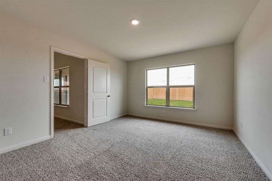 Spare room featuring light colored carpet