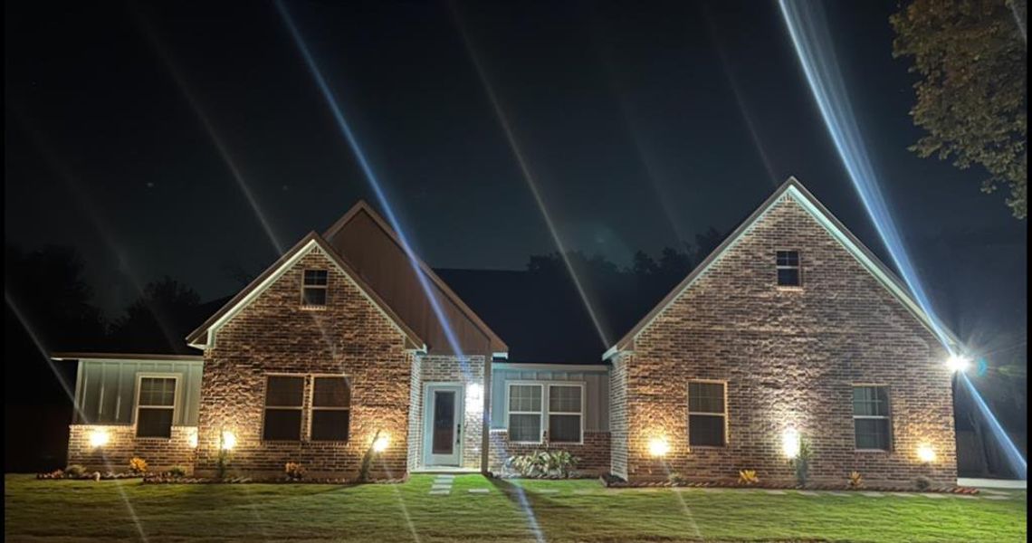 View of front of home with a lawn and brick siding View of front of home with a lawn and brick siding
