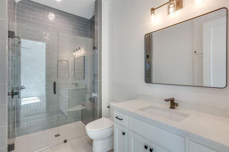 Full bath featuring vanity, a shower stall, and recessed lighting