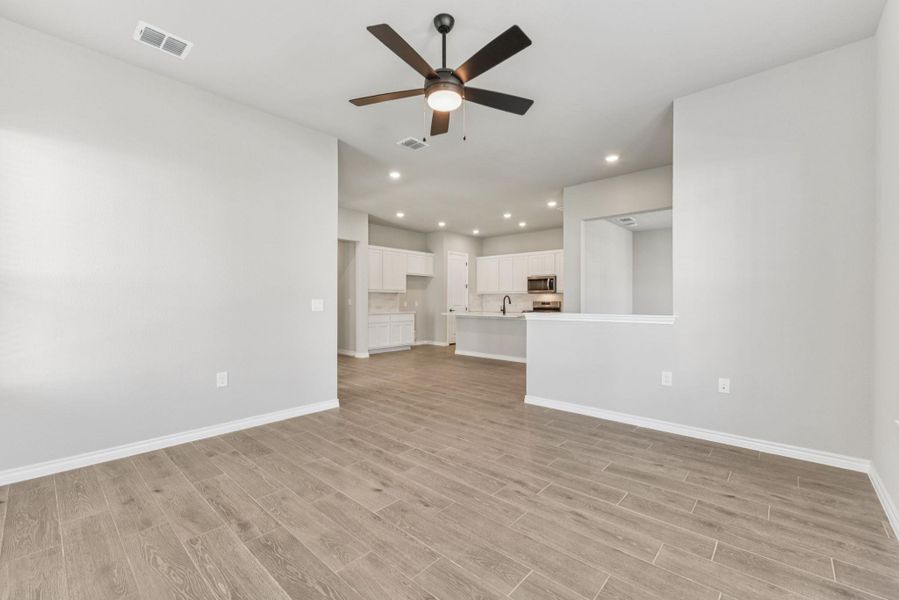 Unfurnished living room with recessed lighting, light wood-type flooring, and ceiling fan