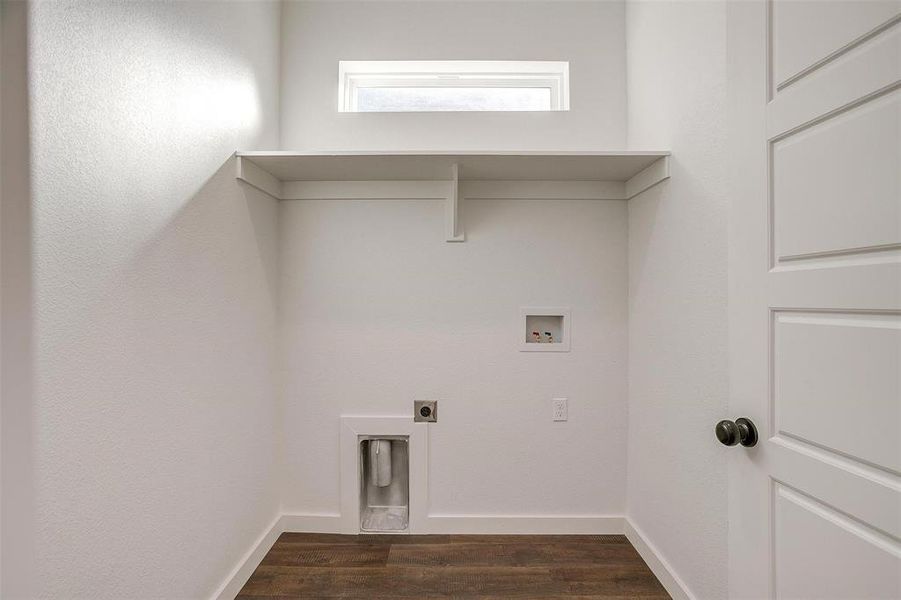 Laundry room featuring dark wood-type flooring, hookup for a washing machine, and hookup for an electric dryer