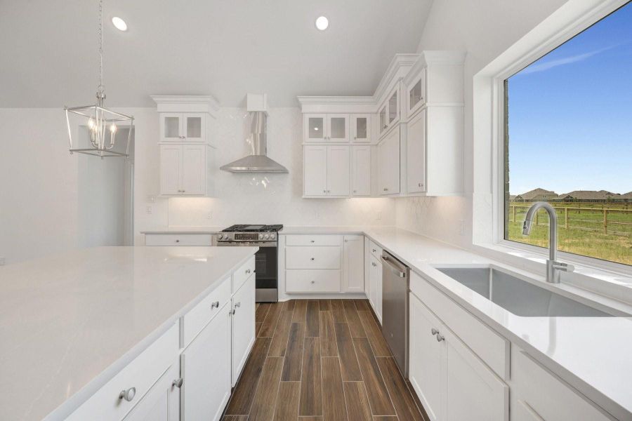 Stylish kitchen with stacked cabinets and quartz counters