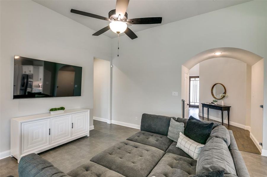 Living room featuring wood-type flooring and ceiling fan