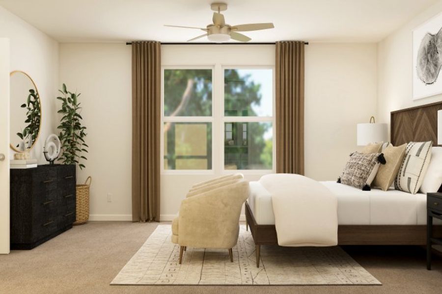 A living room with a white couch and a white chair.