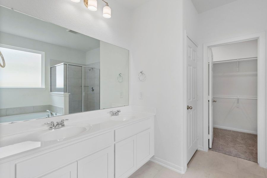 The en-suite bathroom offers a spa-like atmosphere with its elegant design, high end finishes, and tasteful lighting, creating a retreat within your own home. The en-suite bathroom offers a spa-like atmosphere with its elegant design, high end finishes, and tasteful lighting, creating a retreat within your own home.