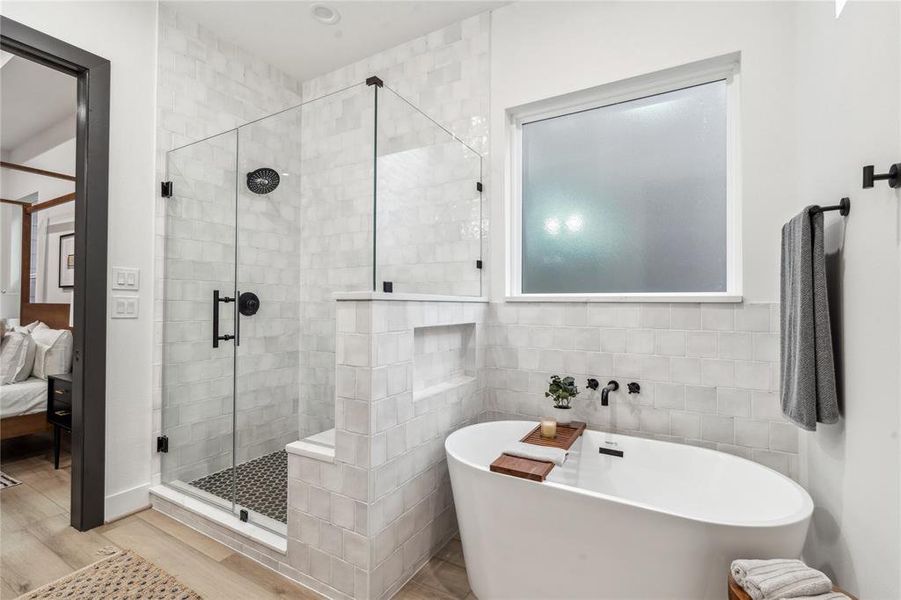 With its sleek walk-in shower and modern freestanding tub, this primary bathroom offers the perfect blend of comfort and sophistication, creating a luxurious retreat