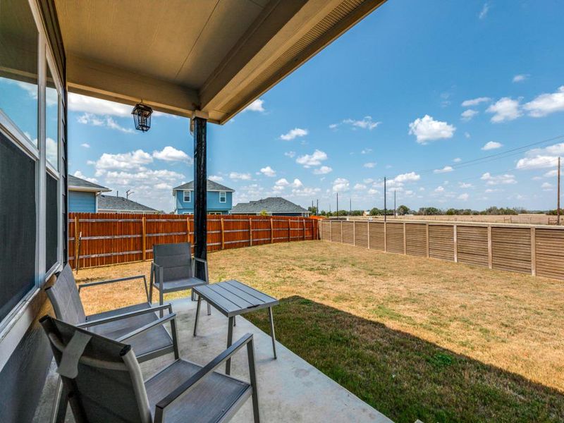 Fenced backyard with a patio area