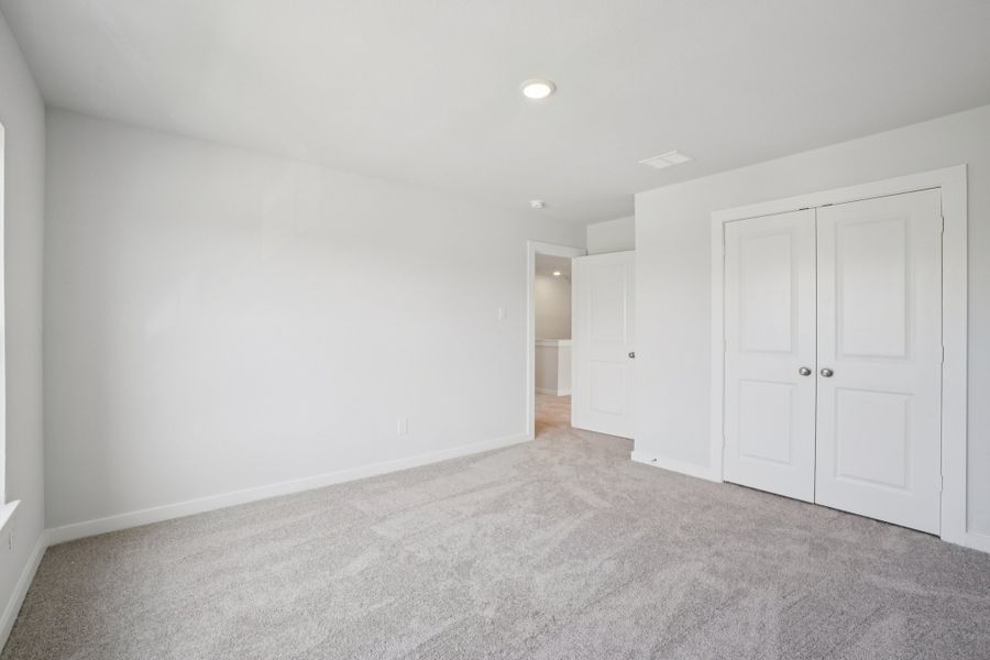 A hallway with white doors.