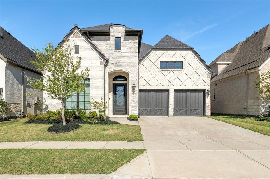 Front exterior of a new home in The Tribute 60', The Colony, TX, highlighting curb appeal (Image 1). Front exterior of a new home in The Tribute 60', The Colony, TX, highlighting curb appeal (Image 1).
