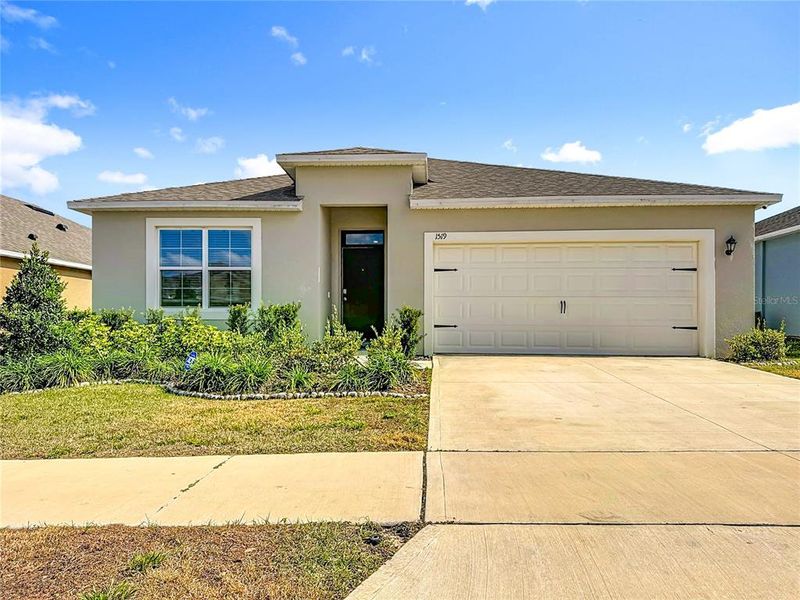 Front exterior of a new home in , Haines City, FL, highlighting curb appeal (Image 2). Front exterior of a new home in , Haines City, FL, highlighting curb appeal (Image 2).