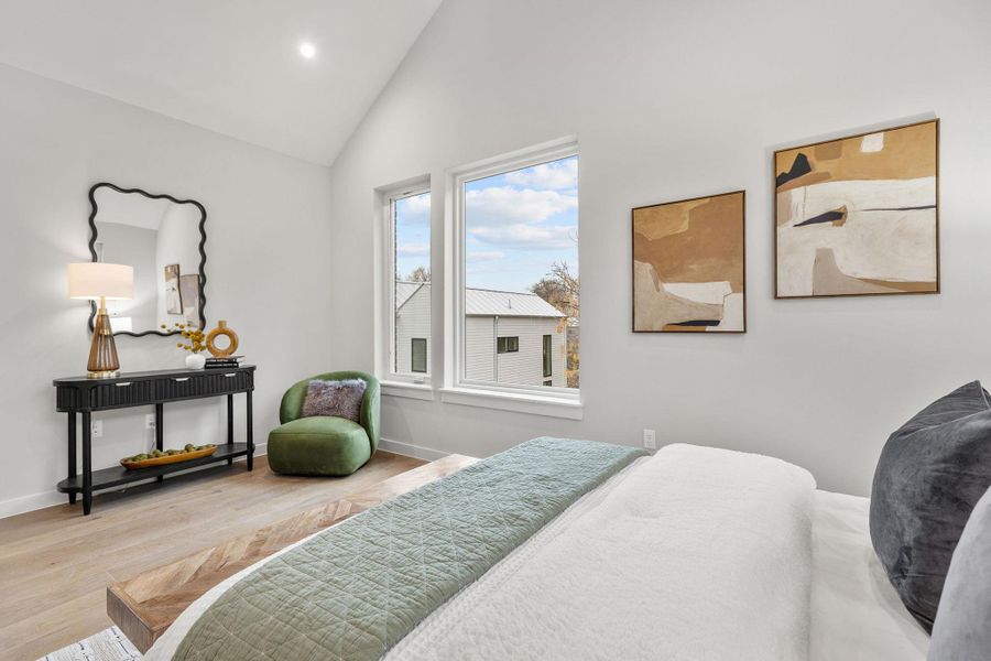 Bedroom with vaulted ceiling, recessed lighting, wood finished floors, and baseboards