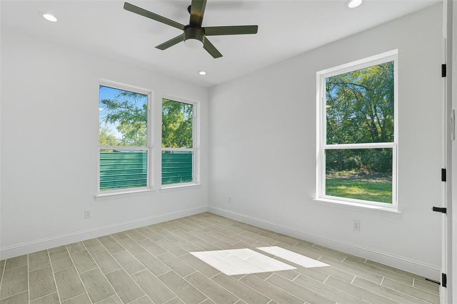 Spare room featuring recessed lighting, wood tiled floors, and a ceiling fan Spare room featuring recessed lighting, wood tiled floors, and a ceiling fan