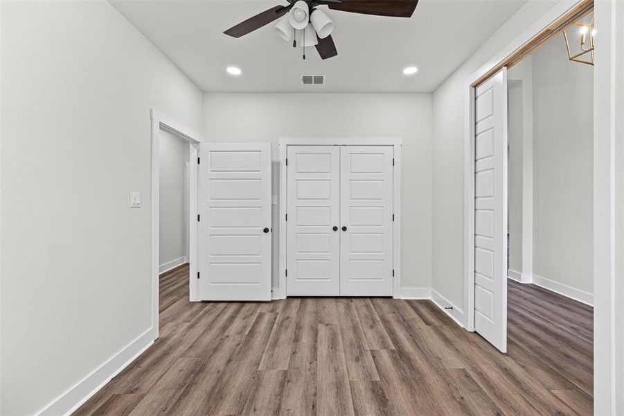 Unfurnished bedroom with dark wood-style floors, a closet, ceiling fan, and recessed lighting Unfurnished bedroom with dark wood-style floors, a closet, ceiling fan, and recessed lighting