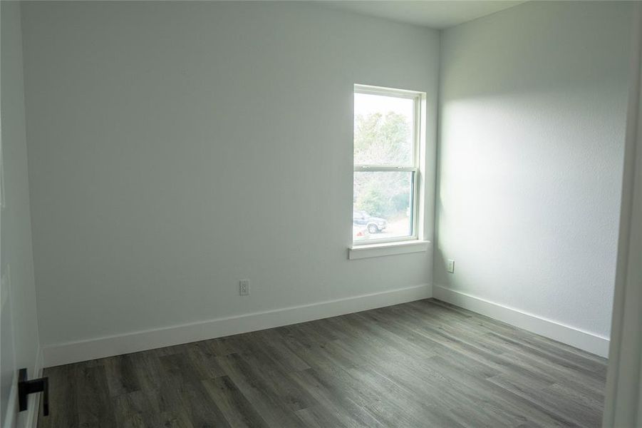 Spare room featuring wood-type flooring