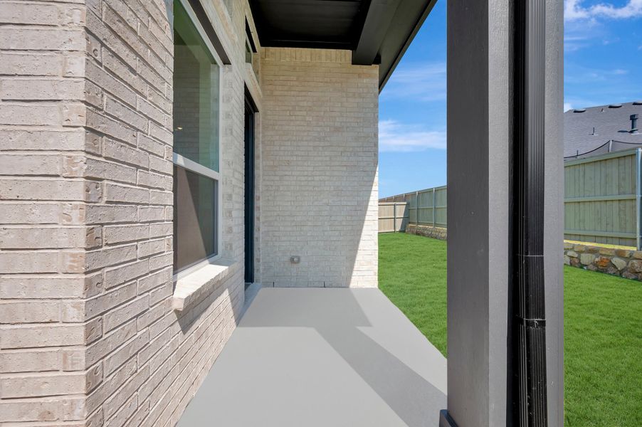 Exterior details and patio area of a home in Pecan Square - Gardens, Northlake (Image 3).