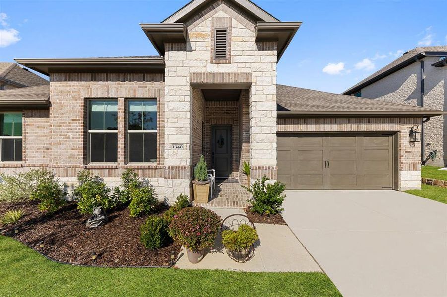 Front exterior of a new home in Monterra, Fate, TX, highlighting curb appeal (Image 2).