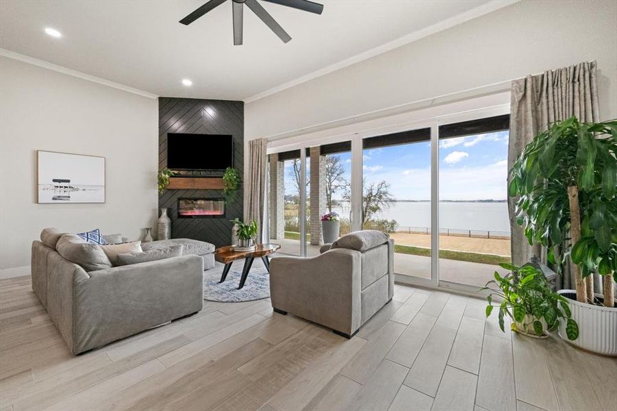 Living room featuring full glass windows, a fireplace, and recessed lighting