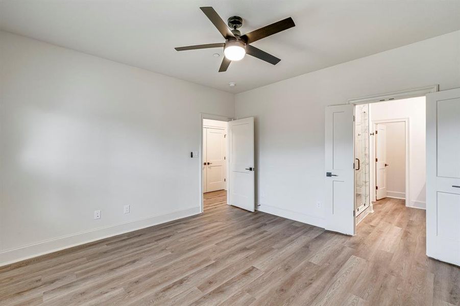 Unfurnished bedroom featuring baseboards, light wood-style floors, and ceiling fan Unfurnished bedroom featuring baseboards, light wood-style floors, and ceiling fan
