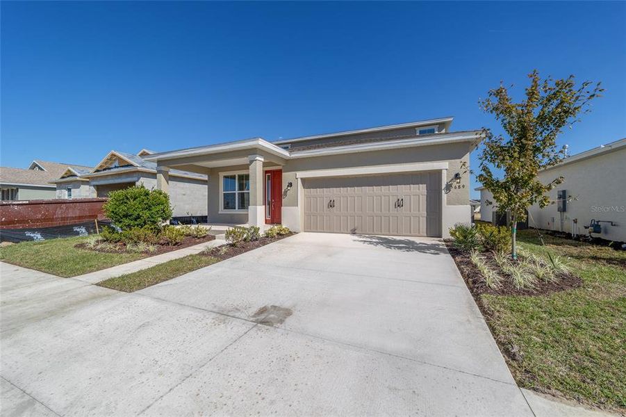 Front exterior of a new home in Calesa Township, Ocala, FL, highlighting curb appeal (Image 21).