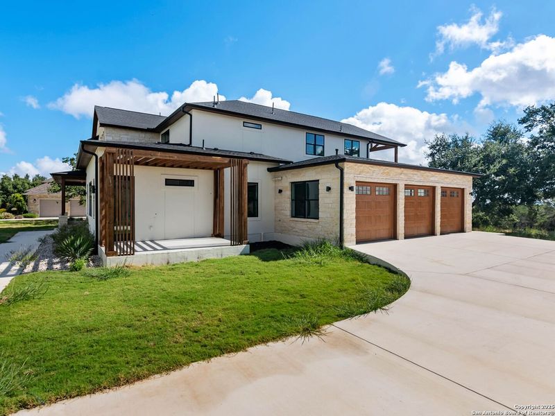 Front exterior of a new home in , Spring Branch, TX, highlighting curb appeal (Image 1).