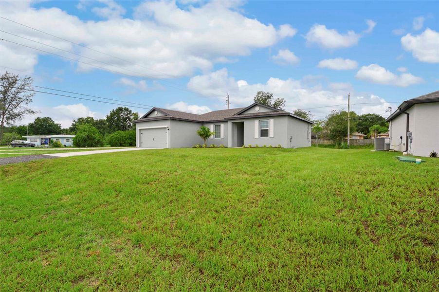 Front exterior of a new home in Vero Lake Estates, Vero Beach, FL, highlighting curb appeal (Image 2). Front exterior of a new home in Vero Lake Estates, Vero Beach, FL, highlighting curb appeal (Image 2).