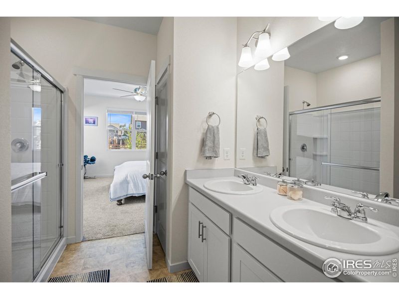 owners suite bathroom with dual sinks