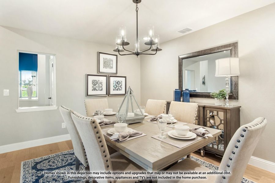 Dining room with gray wood table, upholstered chairs, chandelier, and sideboard with mirror Dining room with gray wood table, upholstered chairs, chandelier, and sideboard with mirror