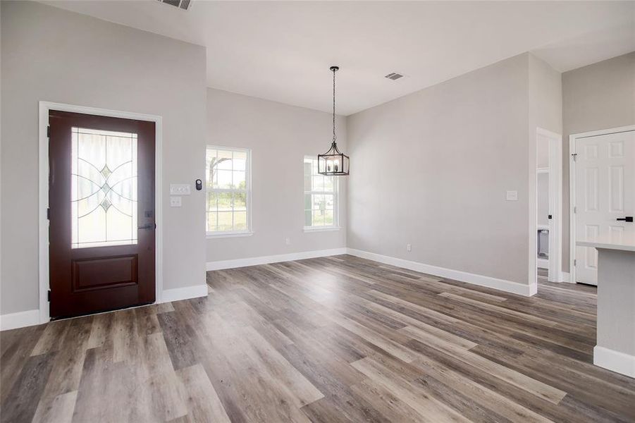 The spacious formal dining area is open to the main living area, which is perfect for entertaining. Featuring a conversation sparking elegant designer chandelier.