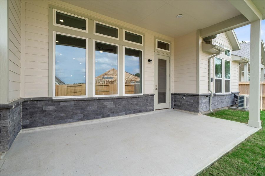 The spacious covered patio offers a tranquil outdoor retreat, perfectly designed for savoring your quiet morning coffee or unwinding during peaceful evening relaxation.