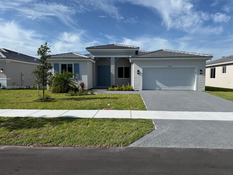 Front exterior of a new home in , Homestead, FL, highlighting curb appeal (Image 21). Front exterior of a new home in , Homestead, FL, highlighting curb appeal (Image 21).