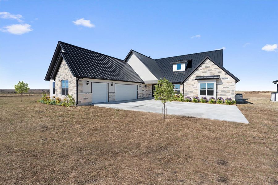 A modern facade with striking dark metal roofs and light-toned stone accents creates a sophisticated presence. A modern facade with striking dark metal roofs and light-toned stone accents creates a sophisticated presence.
