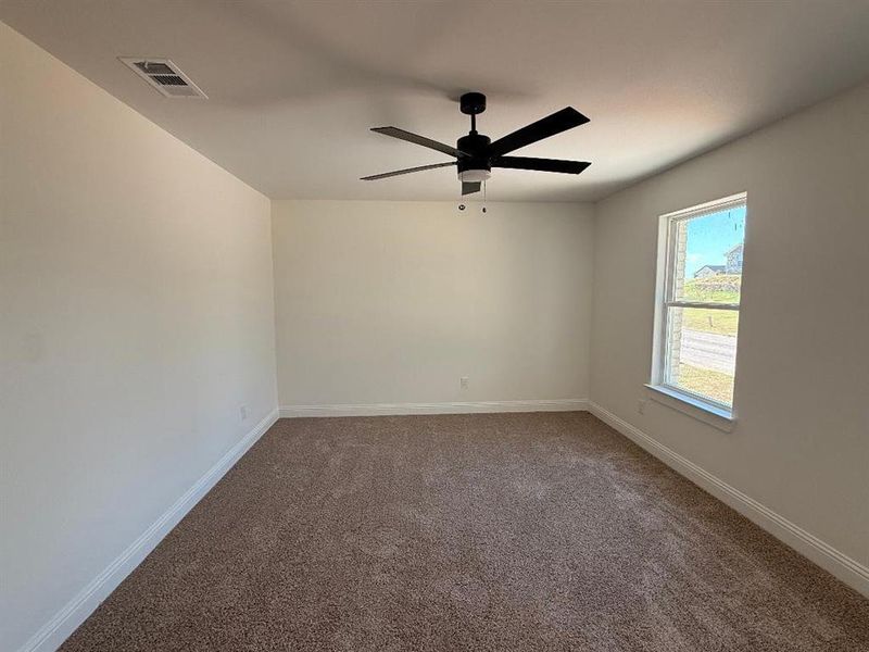 Spare room featuring carpet floors and ceiling fan Spare room featuring carpet floors and ceiling fan