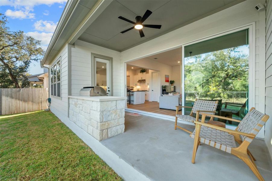 The covered back porch is a grilling enthusiasts dream with a built-in kitchen and grill and space for a beverage fridge.