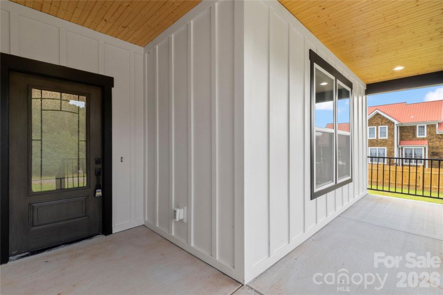 Gorgeous front porch with wood ceiling