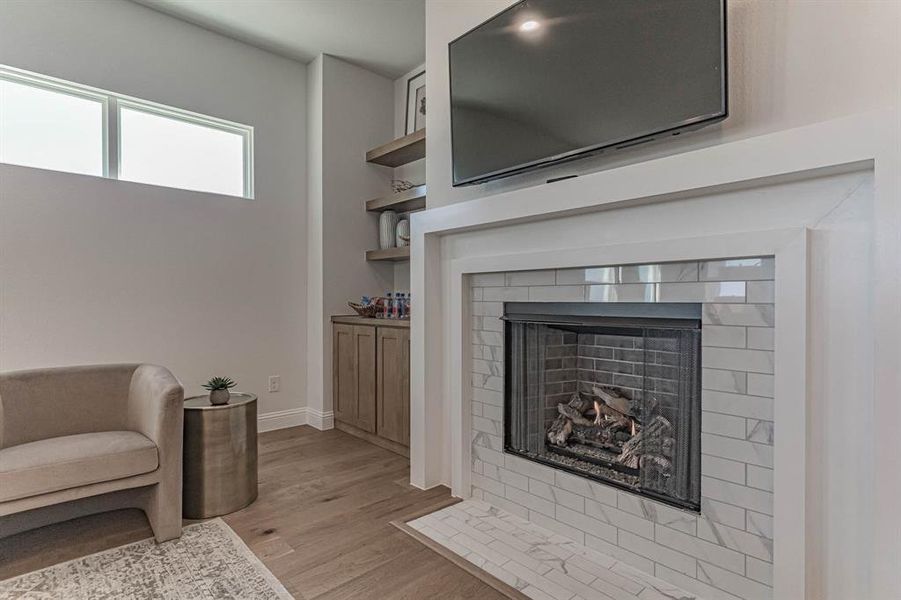 Beautiful ambience provided with ventless fireplace and custom cabinetry built in in living room Beautiful ambience provided with ventless fireplace and custom cabinetry built in in living room