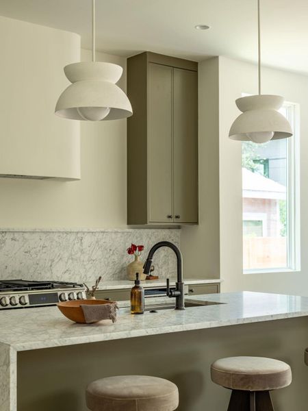 A refined kitchen island with a sleek faucet and stylish bar seating offers modern comfort.