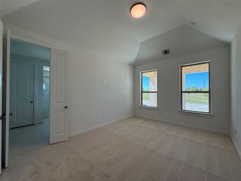 Spacious primary bedroom with high vaulted ceilings. Spacious primary bedroom with high vaulted ceilings.